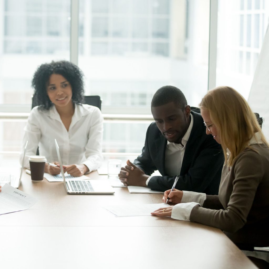 Businessman and businesswoman viewing organisational coaching documents